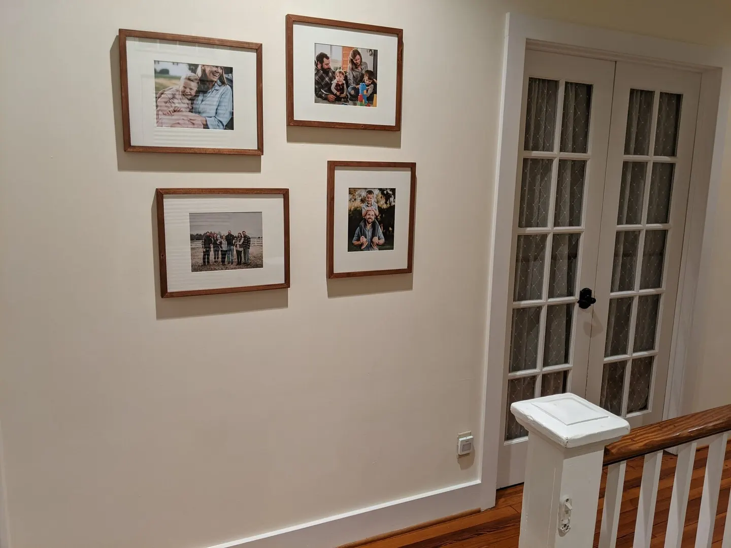 Charlottesville photographer's four wood-framed portraits arranged in a staircase gallery wall