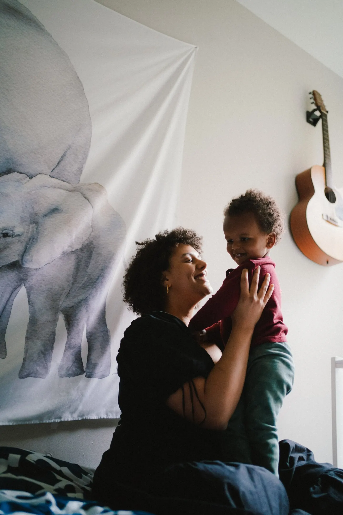 home photos in dark bedroom with mom and son by charlottesville photographer