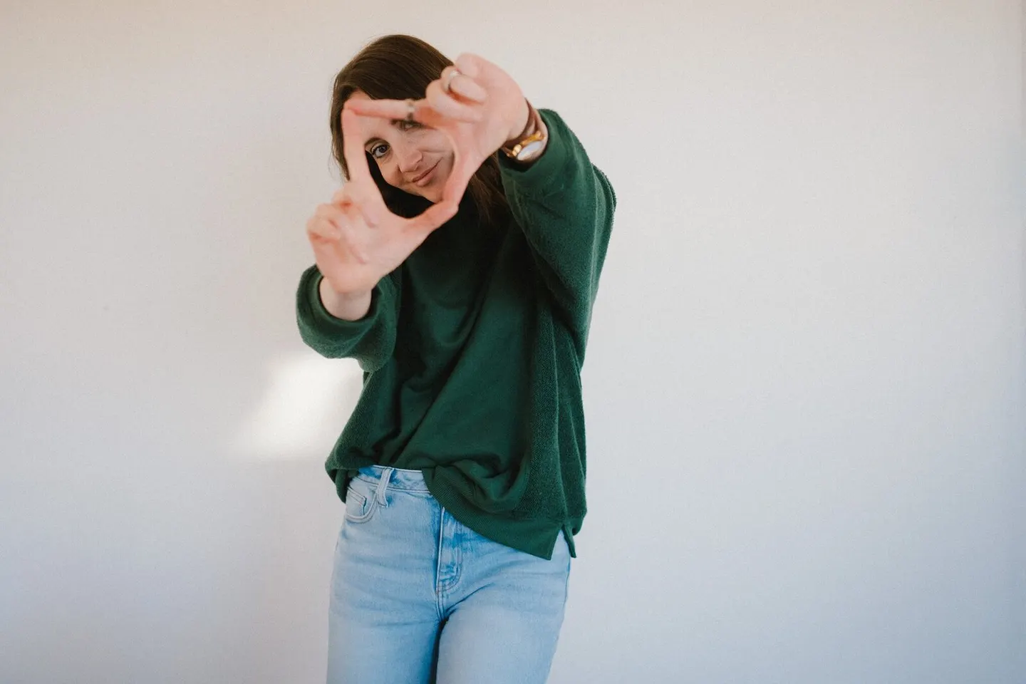 Leah O'Connell framing a shot with her hands, Charlottesville school photographer