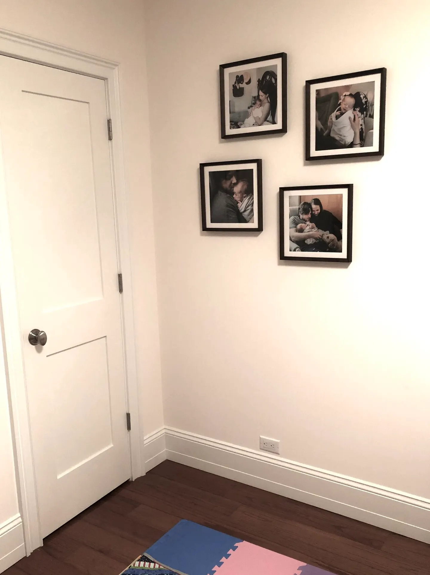 Four square black frames climbing a nursery corner, each holding a newborn-day close-up