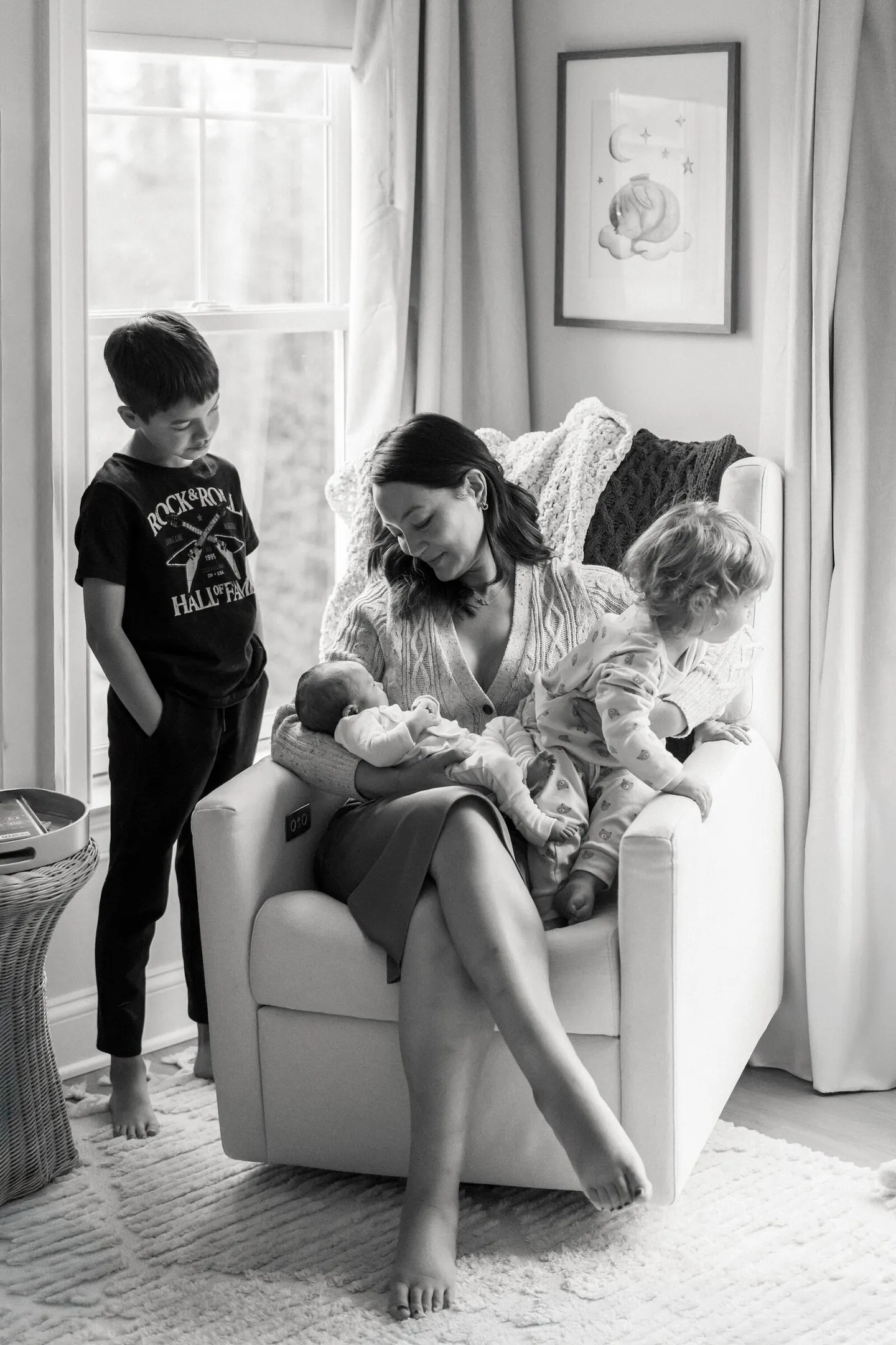 Charlottesville family photographer captures a mother cradling her newborn as older siblings gather close